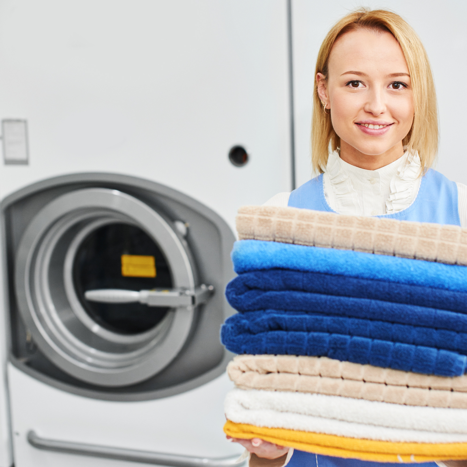 Beautifully folded laundry and smiling professional staff